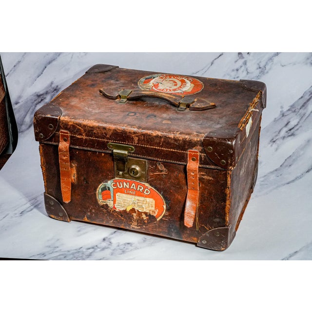 This antique English leather travel case is a richly evocative piece that captures the spirit of early 20th-century travel...