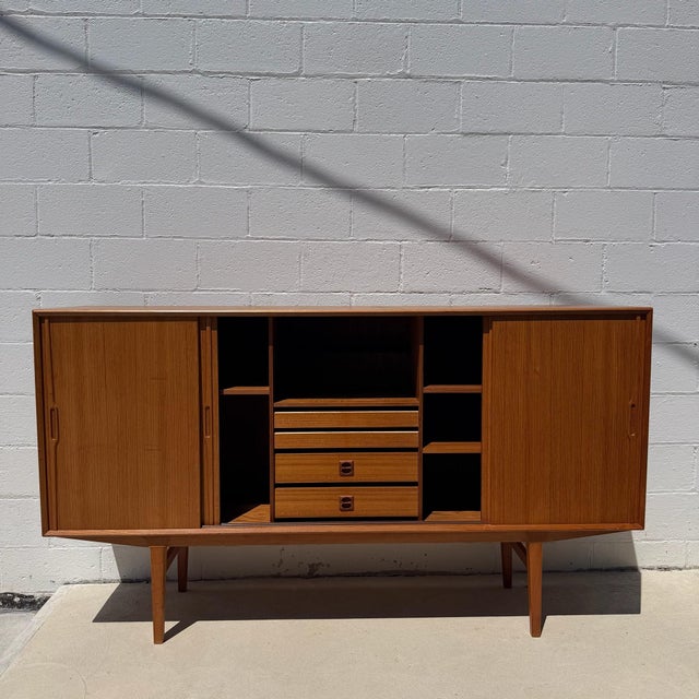 Danish modern teak sideboard by Omann Jun Møbelfabrik, circa 1960s. Crafted in warm, honey-toned teak, the piece...