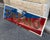 Authentic Cinzano enamel advertising sign, featuring the famous two-tone blue and red graphic with embossed lettering. An...