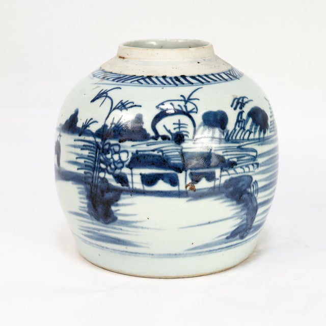 A fine antique Chinese Export porcelain ginger jar. In the Canton pattern. Decorated in underglaze blue with a mountainous...