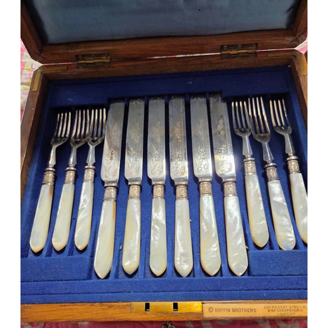 An exceptional, complete 24-piece antique Victorian dessert and fruit cutlery service manufactured by the prestigious...