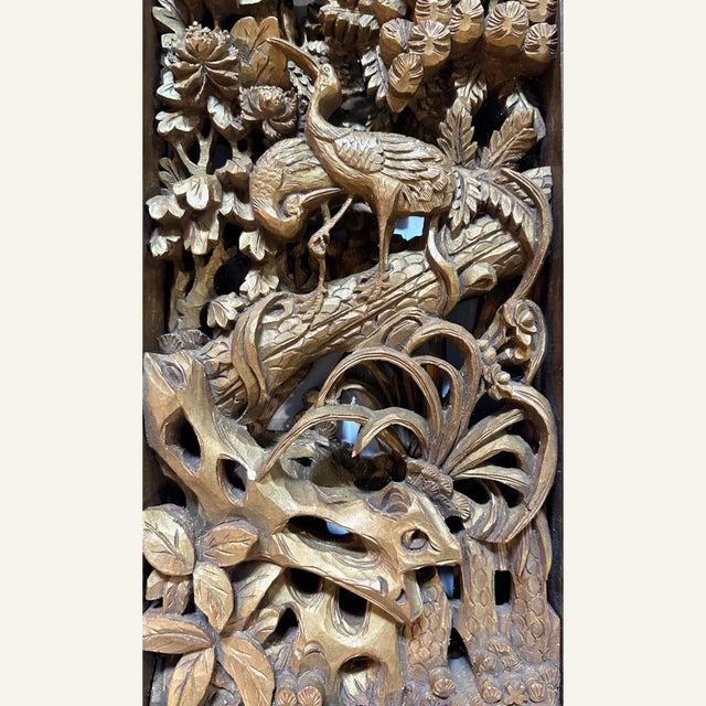 This Chinese carved panel from the first half of the 20th century features a carved bird and pine tree motif. The piece...