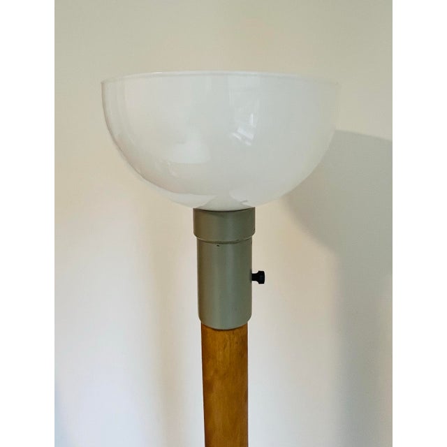 Kurt Versen mid-century modern floor lamp with single light above a teak wood column over an enameled metal base. 53”H...