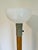 Kurt Versen mid-century modern floor lamp with single light above a teak wood column over an enameled metal base. 53”H...