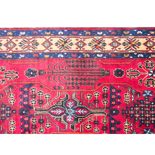 This vintage Anatolian Turkish rug features a vibrant red field adorned with intricate geometric and botanical motifs....