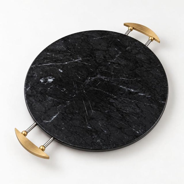 An elegant, round tray from the 1990s by La Galleria, crafted from polished black Marquina marble and embellished with...