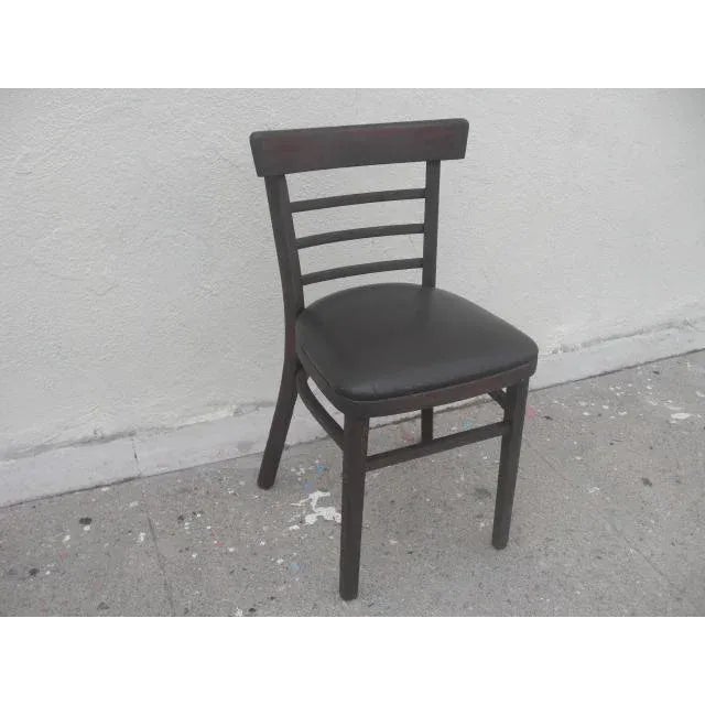 Old school, vintage desk wooden desk chair with ladder back and cushioned vinyl seat. Dark brown stained wood with...