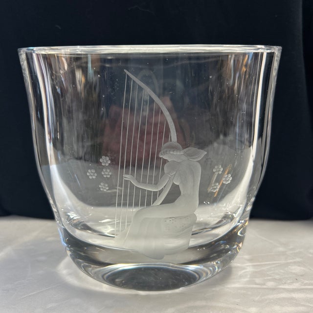 Beautiful crystal vase by Orrefors with an etched woman harpist. Very pretty and signed.