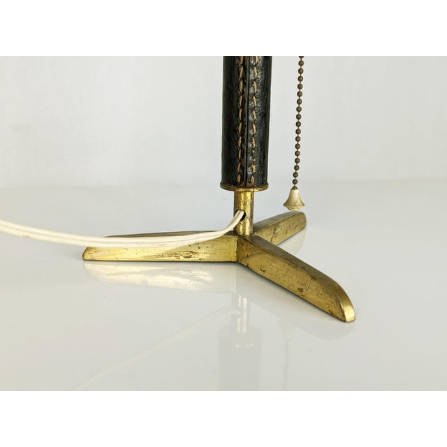 Small table lamp/abat jour made of brass structure with brown leather coating. Chain switch incorporated in the lamp...