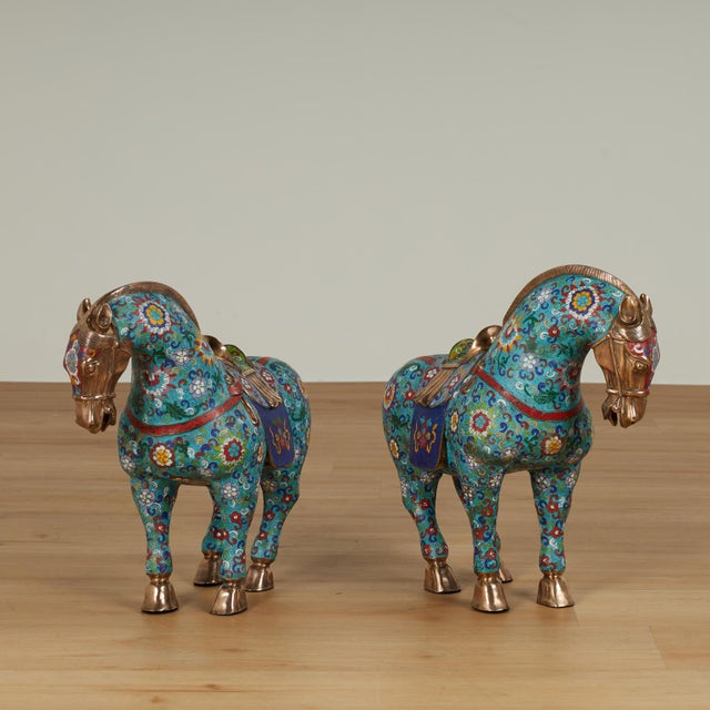 Standout pair of vintage Chinese horses crafted in brass in classic form and hand decorated in a cloisonne enamel...