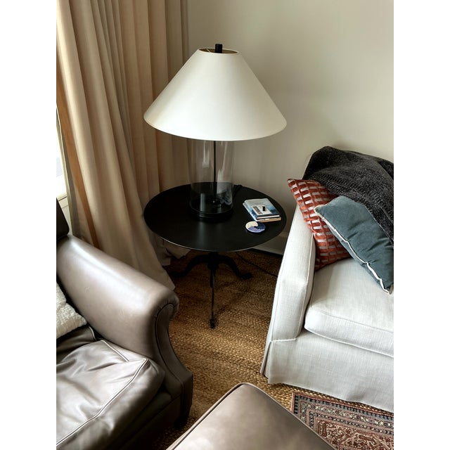 Pair of cylinder glass lamps in style of John Saladino with linen shade, black hardware, white coolie shade