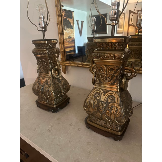 An extraordinary pair of monumental vintage brass urn table lamps, distinguished by their commanding proportions,...