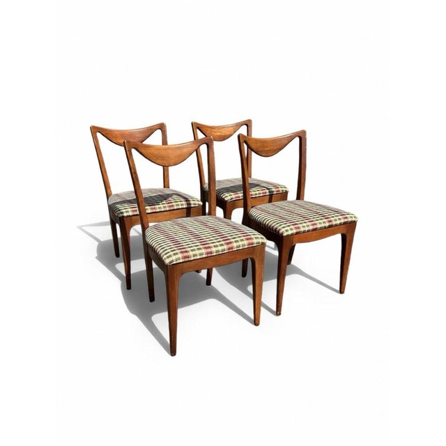The 1950s Drexel Dining Chairs from the Dateline Collection are a set of 4 mid-century modern chairs crafted from walnut...