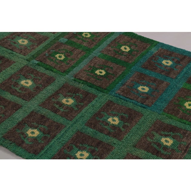 Made with hand-knotted high-pile wool in Turkey, this 3x6 vintage Tulu rug is a distinguished addition to Rug & Kilim’s...