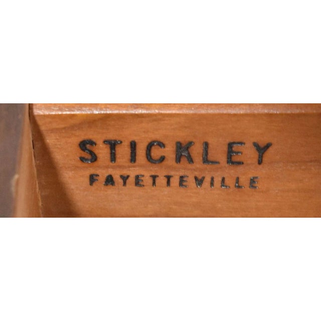 Top with molded edge over skirt with single dovetail drawer with solid brass handles and pulls resting on cabriole legs...