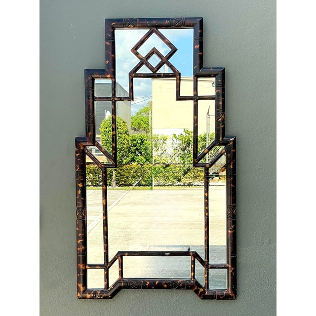This striking vintage wall mirror is a masterclass in Hollywood Regency glamour and Chinoiserie elegance. The...