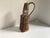 Charming vintage wicker-wrapped bottle in a classic French country style. Features a unique square shape with a sturdy,...