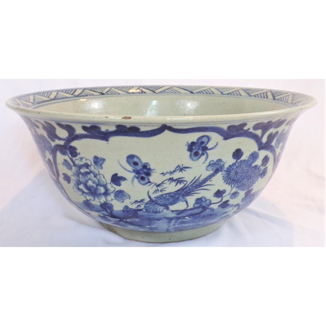 This is a beautiful Chinoiserie blue and white extra large bowl. It has chrysanthemums surrounding the vignette of the...