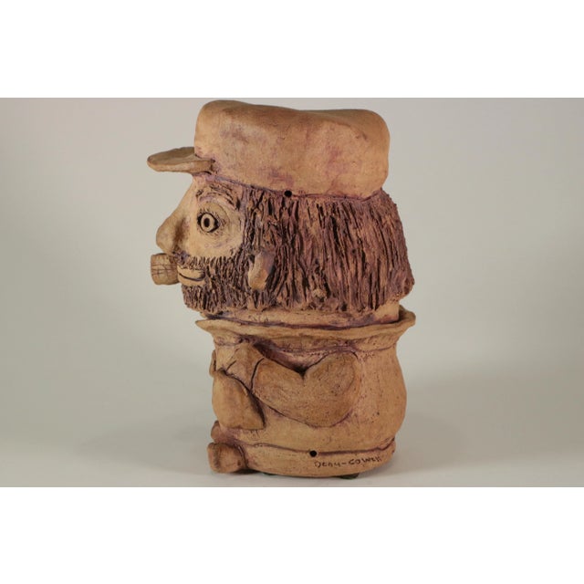 Charming folk art stoneware fisherman with a short billed cap and corn cob pipe. I acquired this fellow from the estate of...