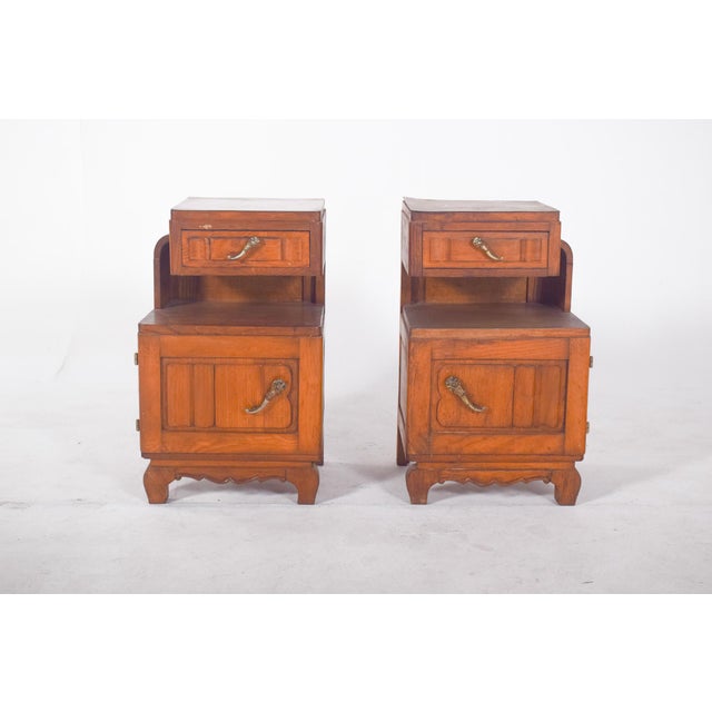 Pair of oak bedside tables. With a traditional design and robust structure, they have an upper drawer with a metal handle...