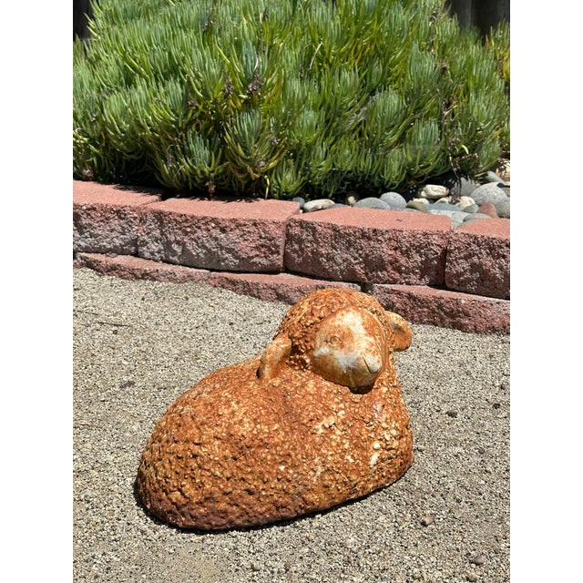 Charming vintage cast iron sheep with a weathered, rustic patina. This solid piece features textured wool detailing and a...