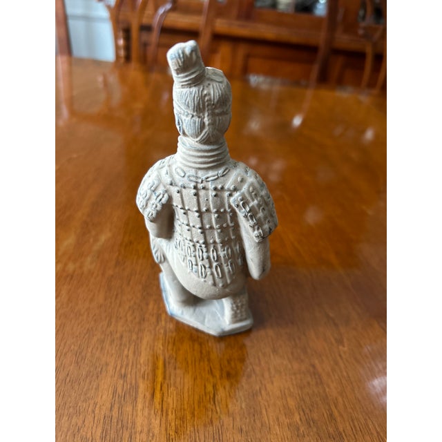 A detailed reproduction of one of the famous kneeling archers from China's Terracotta Army, originally excavated near...