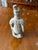 A detailed reproduction of one of the famous kneeling archers from China's Terracotta Army, originally excavated near...