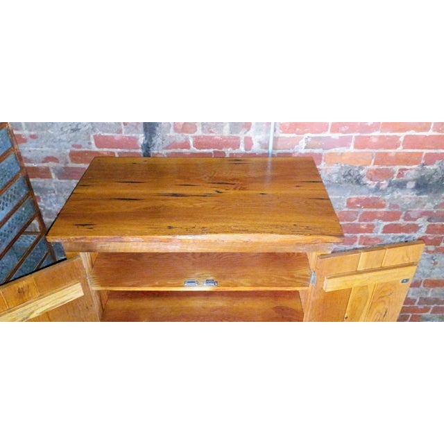 Brimming with authentic character and rustic warmth, this handcrafted two-door storage cabinet is custom-built from...
