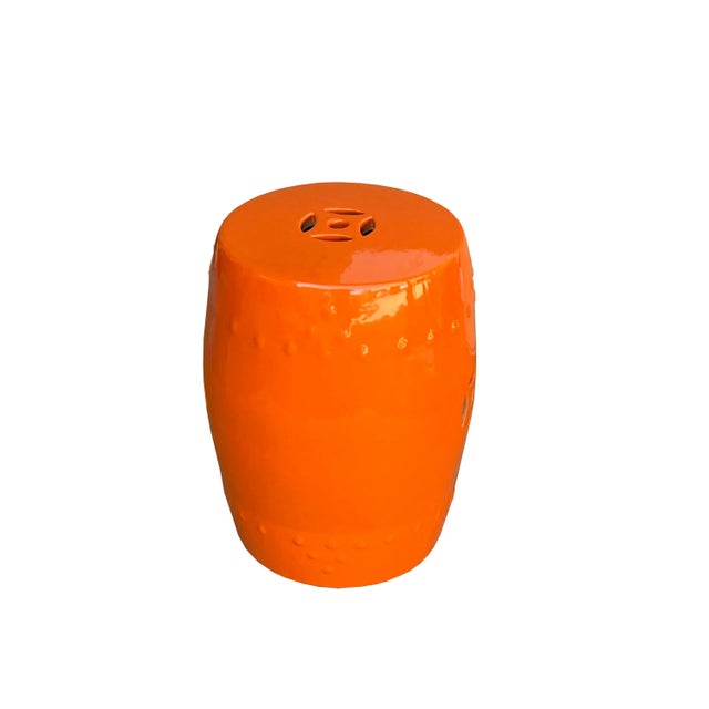 This is a simple round shape porcelain stool with solid orange #EB4C00 color finish. There are oriental double coin...
