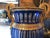 A pair of 20th century blue bohemian crystal urns. The pair feature etched and beveled crystal with gilt bronze handles...