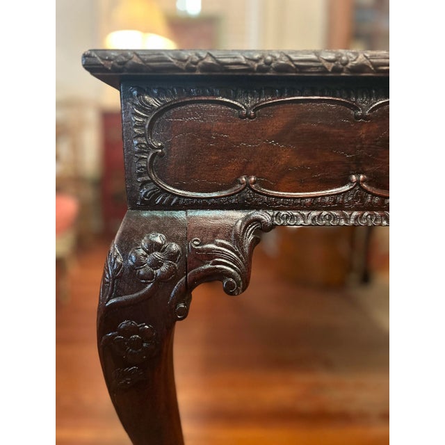 A commodious, Georgian style mahogany writing desk, the top over a single, deep drawer and finely carved apron. The edges...