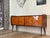 Italian vintage sideboard. Exclusive chevron wood veneer. Sleek, gently rounded side shapes recall the golden age of 20th-...