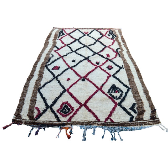 One-of-a-kind hand-knotted Moroccan rug in soft, organic wool with an ornate rhythmic pattern of Berber diamonds and...