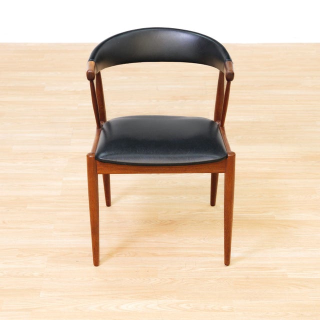 Designed by Johannes Andersen, this Danish teak armchair is a beautiful example of Scandinavian mid-century design....