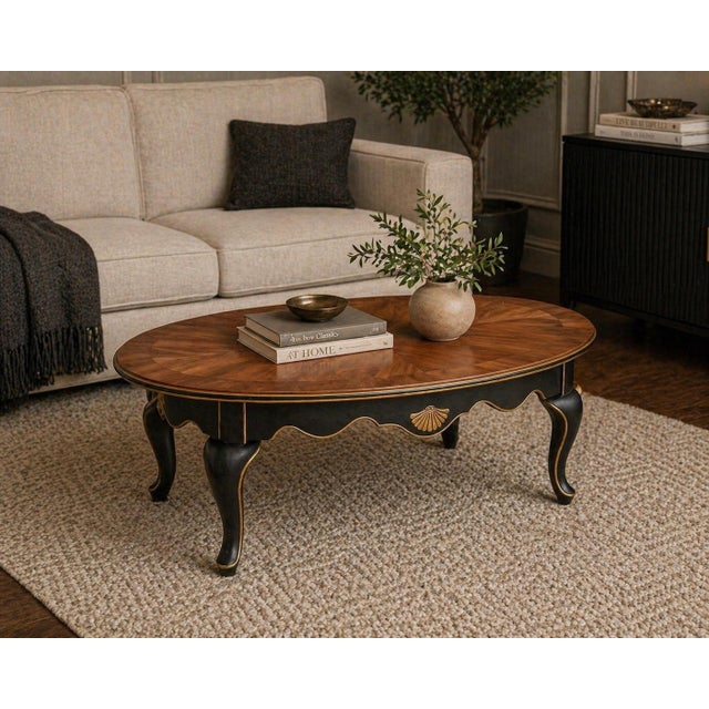 Vintage Oval Coffee Table – Bookmatched Veneer Top in Satin Walnut with Black & Gold Gilded Base – 48" W A refined...