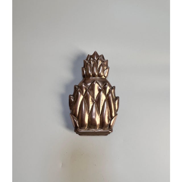 Vintage solid brass door knocker in the shape of a pineapple. The tones on the brass front are a nice light coppery shade....