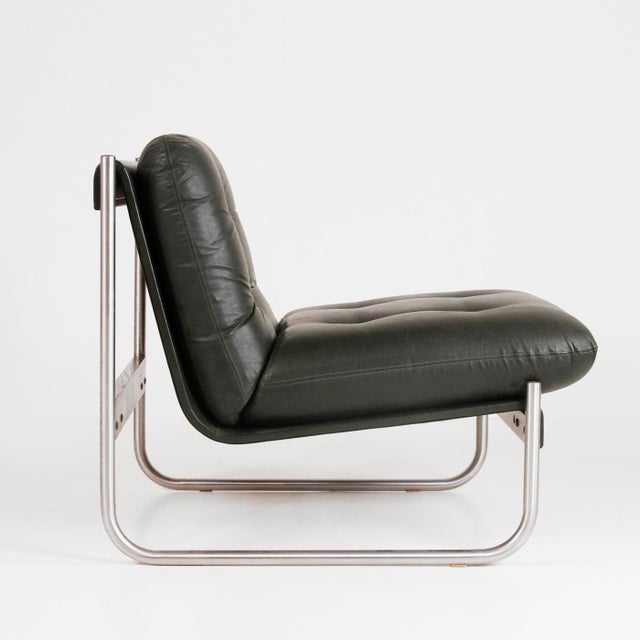 Italian-made armchair from the 1970s. The original dark green faux leather is in very good condition and shows no signs of...