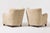 An elegant pair of Danish Modern armchairs from 1940s Denmark, distinguished by their sculptural silhouette and inviting...