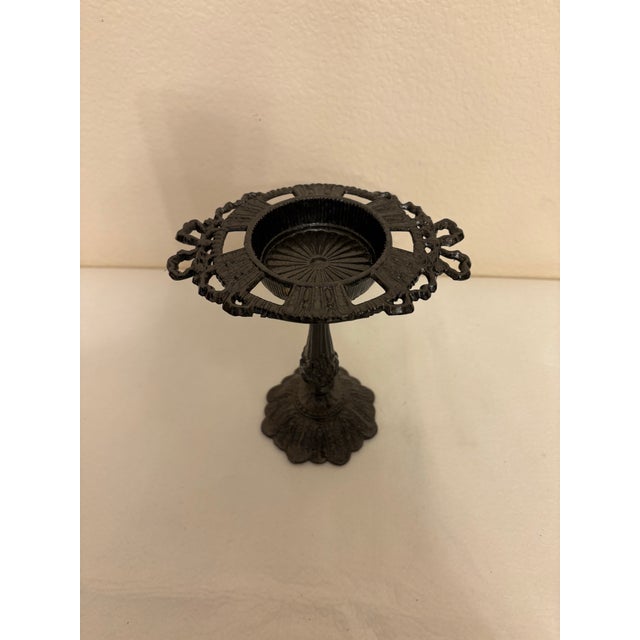 Add a touch of moody elegance and vintage drama to your interior with this striking black cast iron pillar candle holder....
