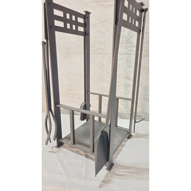 This fireplace tool set includes a brush, shovel, and tongs.