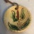 Set of 2 yellow slip ware ornaments - lead glaze. Both ornaments have a floral motif. Twine hangers are included
