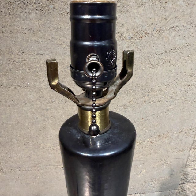For your consideration a mid century modern black ceramic table lamp. Mounted in wood base wiht brass rim at the bottom....