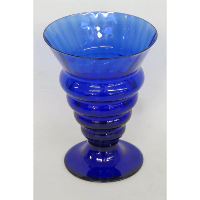 This stunning Ribbed Goblet / Vase is made of glass. This lovely footed vessel features a gorgeous cobalt blue color...