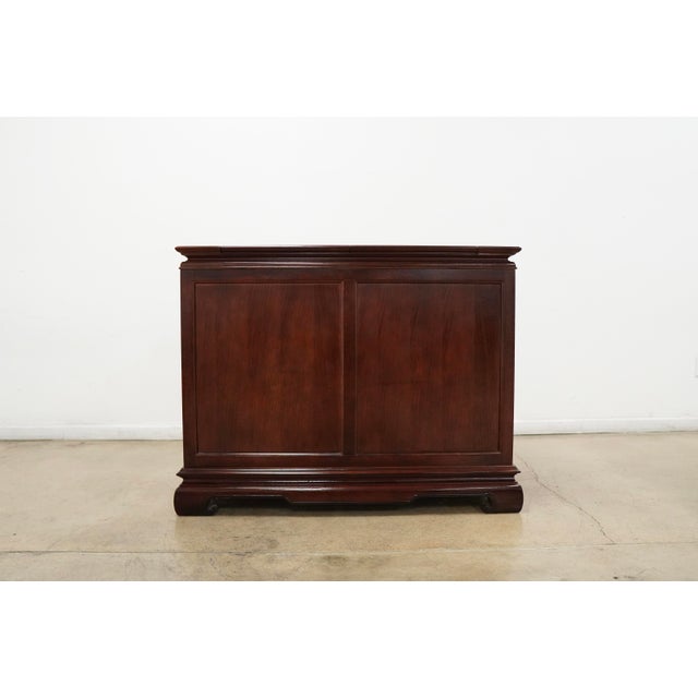 Vintage Asian-inspired Universal Furniture flip top server featuring rich cherry-toned wood construction with beautifully...