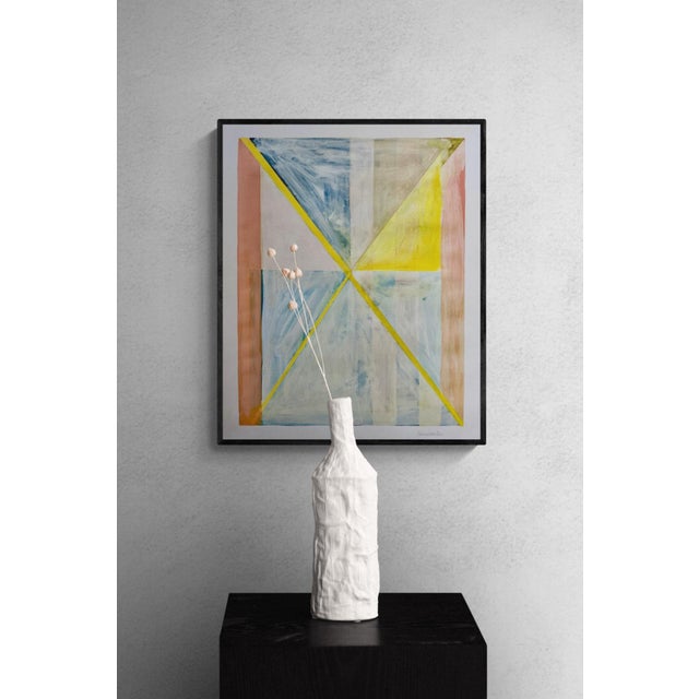 This piece features geometric shapes made of acrylic paint washed over color pencil lines and shapes faded into the...