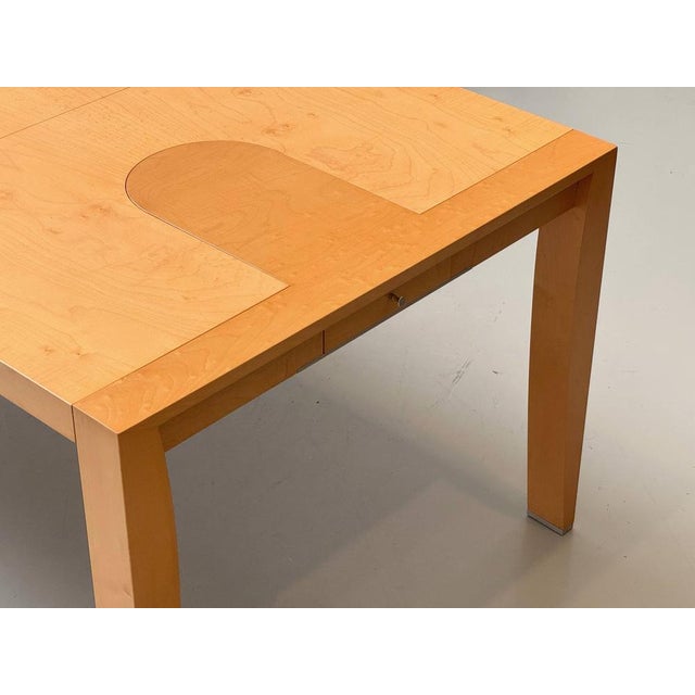 An elegant extendable dining table by renowned designer chi wing lo, crafted by the italian luxury furniture manufacturer...