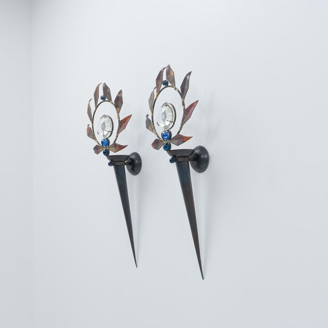 A pair of "olympia" wall sconces by mark brazier-jones, forged from iron with a copper sheet laurel garland and glass...