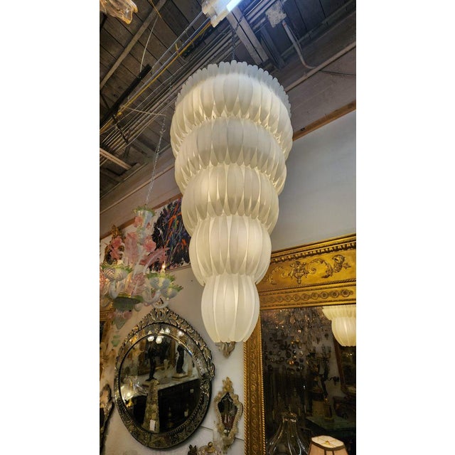 This listing features a tall, frosted glass tiered chandelier that is hardwired and ready to use. Likely originated from...