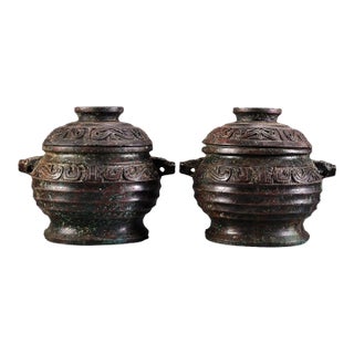 Pair of Antique Bronze Lidded Jars With Archaic Scrollwork For Sale