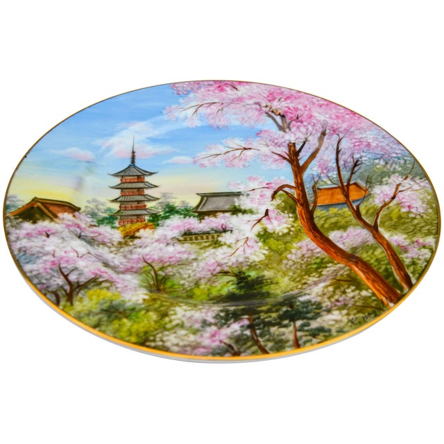 Vintage gold Japanese porcelain plate hand-painted with intricate floral pattern and ornate peacock details in vibrant...